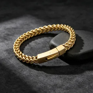 Close-up of gold stainless steel wheat chain bracelet with secure square clasp detail