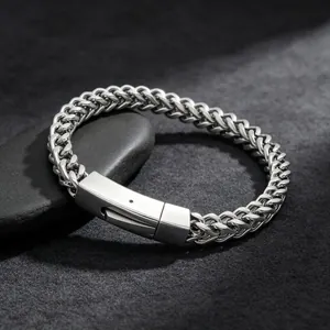 High-quality macro view of a stainless steel wheat chain bracelet with a square plug clasp.