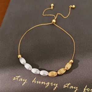 Detail view of vintage bicolor textured beads on a gold drawstring sliding bracelet