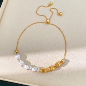 Detailed view of vintage gold and silver oval textured beads on a pull-type bracelet