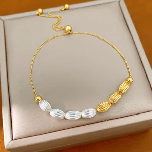 Detailed close-up of a vintage two-tone bracelet with textured oval beads and sliding clasp