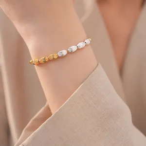 Detail of a vintage adjustable bracelet with oval textured beads in gold and silver.