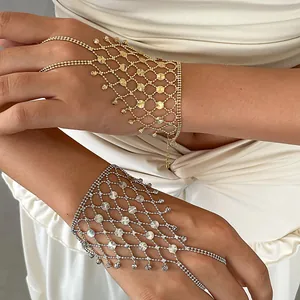 Detail view of hollow geometric gold and silver tassel integrated ring bracelets