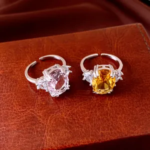 Close-up of elegant open rings featuring pink and yellow oval zircon center stones.