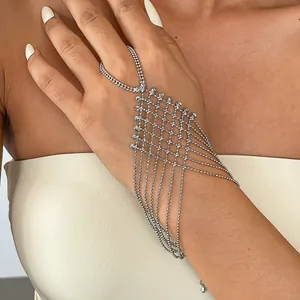 Detailed view of a silver-tone geometric mesh hand harness with layered ball chain tassels