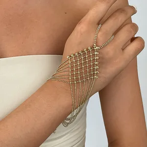 Detailed view of an elegant gold mesh slave bracelet featuring delicate bead chain tassels