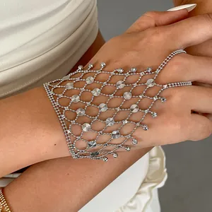 Close-up detail of a silver hollow geometric mesh hand chain bracelet with tassels