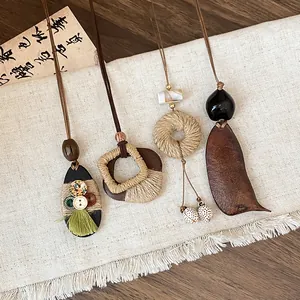 Detailed view of four retro ethnic style wooden and woven pendant necklaces.