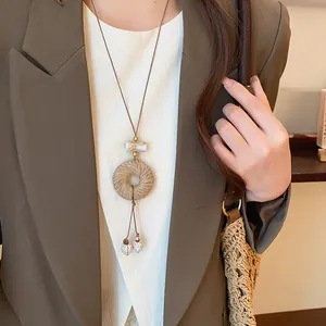 Detailed view of a retro new Chinese style rope-wrapped geometric pendant necklace