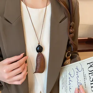 Macro view of New Chinese style retro wooden geometric pendant necklace on model