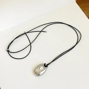 Minimalist Korean style silver oval hollow pendant necklace with thin black leather cord