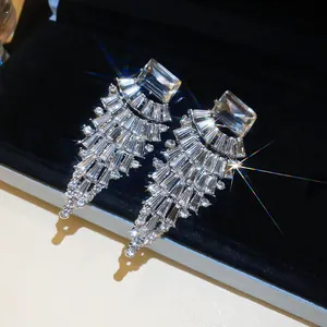 Macro view of luxurious fan-shaped pendant earrings with brilliant clear rhinestones