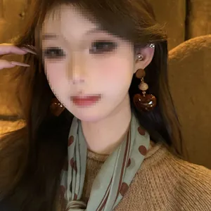 Detailed close-up showing Maillard style brown resin heart-shaped earrings on a model