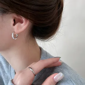 Close-up of elegant 18k gold plated honeycomb hoop earrings with zircons