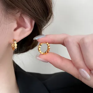 Close-up of 18k gold plated honeycomb hoop earrings with shimmering zircon accents