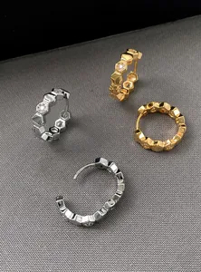 Detailed macro view of 18k gold and silver plated honeycomb hoop earrings with zircons