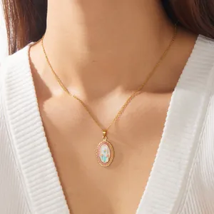 Close-up view of a French vintage style gold-plated necklace with an enamel flower pendant