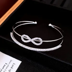 Double-layer open infinity bangle with sparkling cubic zirconia in a silver finish.
