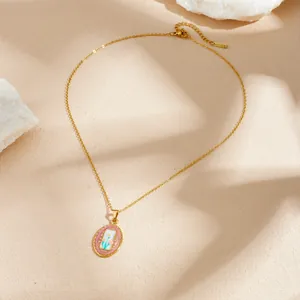 Close-up of French vintage gold-plated enamel flower oval pendant necklace