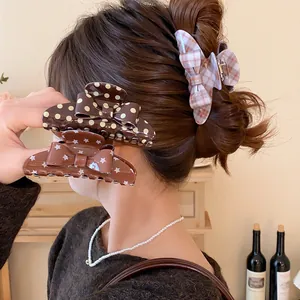 Vintage Korean bow shark clips featuring polka dot, star, and plaid patterns shown on hair