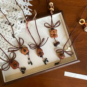 Handmade wooden bear and dog pendant necklaces with cute coffee bean accents on cord