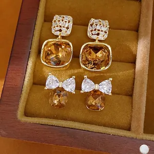 Luxury 14k gold plated earrings set with amber cubic zirconia in square and bow-tie designs