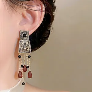 Vintage palace style square tassel earrings with elegant beads shown on model