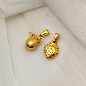 Close-up of 18K gold plated stainless steel lemon and strawberry fruit pendants