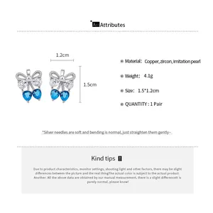 Detailed view of silver needle bow-knot earrings with blue heart zircon and size specs.