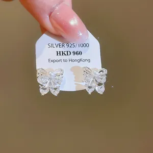Macro view of exquisite 925 silver butterfly stud earrings with sparkling zircons