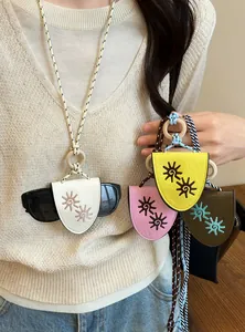 Close-up of leather eyeglass holder necklaces featuring sun embroidery and braided ropes.