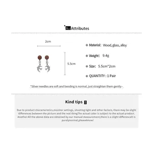 Detailed specifications of vintage swallow drop earrings with wood and glass bead accents