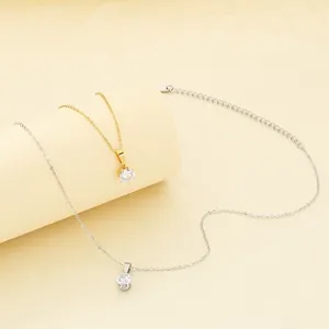 Detailed view of minimalist gold and silver necklaces with round cubic zirconia pendants.