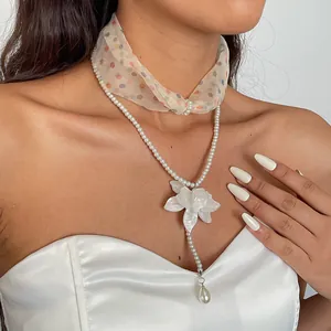 Elegant pearl and resin flower double-layer necklace with chiffon polka dot choker detail