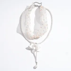 Double-layer pearl necklace with chiffon polka dot scarf and white flower pendant