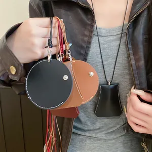 Close-up detail of stylish leather pouch pendants and clochette necklace for accessories