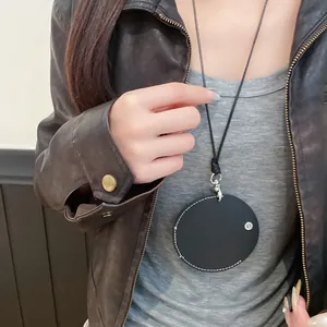 Detailed view of a round leather pendant necklace worn as a stylish eyeglass holder.