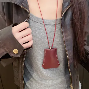 Stylish leather cloche pendant necklace shown as a functional eyeglass holder on a model