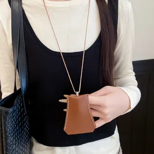 Close-up of a brown leather necklace doubling as a stylish glasses holder pendant accessory