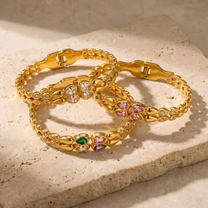 Detailed view of luxury gold stainless steel bangles with colorful teardrop cubic zirconia