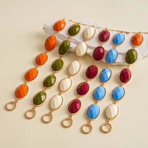 Detailed macro view of vintage gold-tone bracelets with colorful oval resin stones