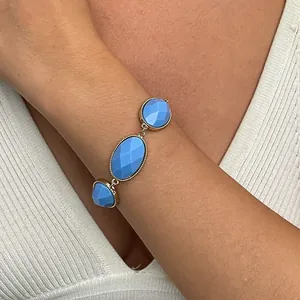 Detailed view of vintage gold metal bracelet with blue faceted resin ovals