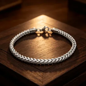 Detailed view of a 3mm stainless steel dragon bone chain bracelet on a wooden gift box.