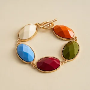 Vintage gold metal bracelet with colorful oval resin stones and toggle clasp detail