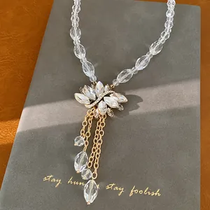 Elegante detailopname van een glazen kralenketting met stras lotus en druppelkwastjes