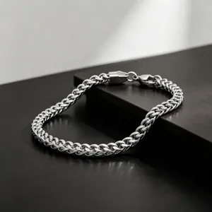 Macro view of polished 3mm stainless steel Franco chain bracelet with lobster clasp