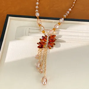 Elegant vintage amber glass bead tassel necklace with a crystal butterfly pendant