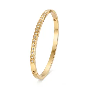 Detailed view of a gold stainless steel bangle with sparkling crystal pave settings.