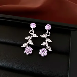 Elegant silver-tone flower and leaf stud earrings with sparkling purple crystals decoration