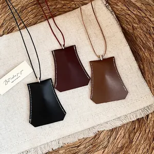 Minimalist geometric leather key pouch necklace in black, burgundy and brown tones